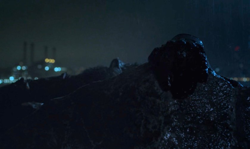 Matt Murdock's hand on a rainy rock at night.
