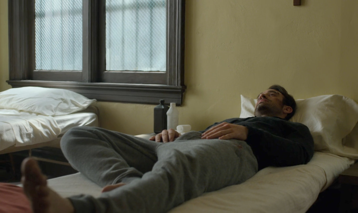 Matt in a bed at St. Agnes Orphanage.