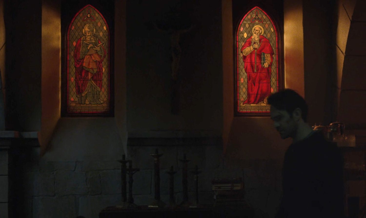 Matt by stained glass windows in the church basement.