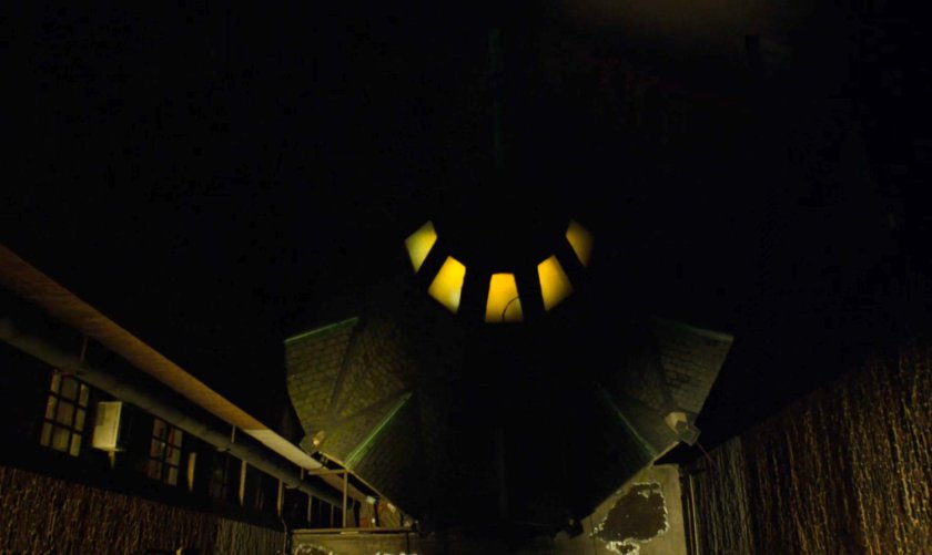 Aerial view of church rooftop at night.