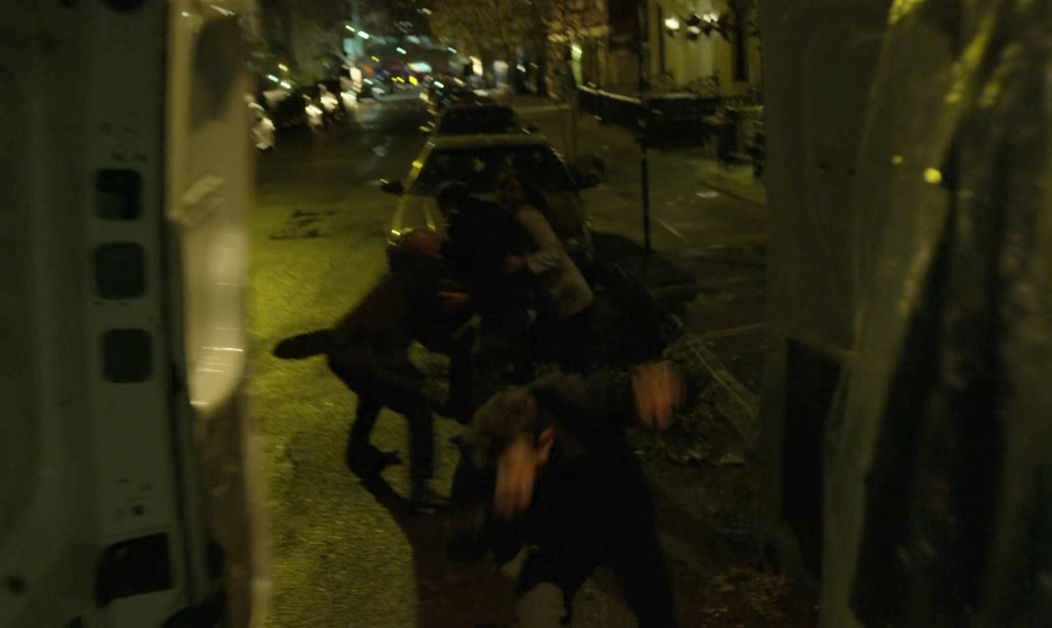 A man and woman abducted on a dark street as seen from inside a van