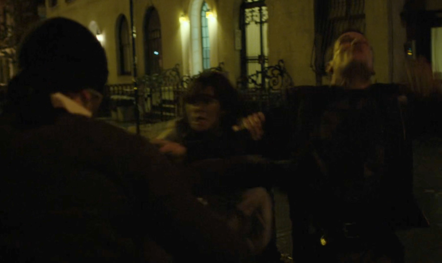 The Man in Black fights two kidnappers on a dark street.