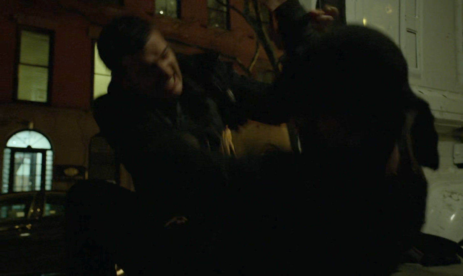 The Man in Black fights a kidnapper on a dark street.