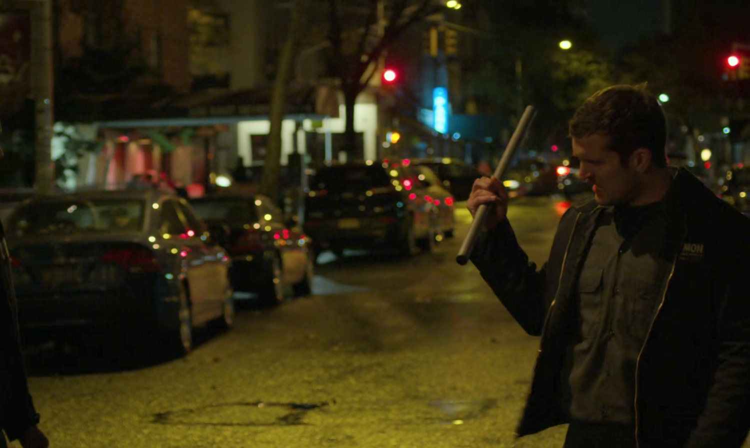 A kidnapper with a pipe on a dark street.