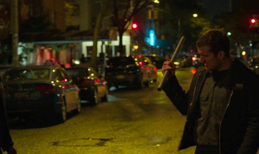 A kidnapper with a pipe on a dark street.