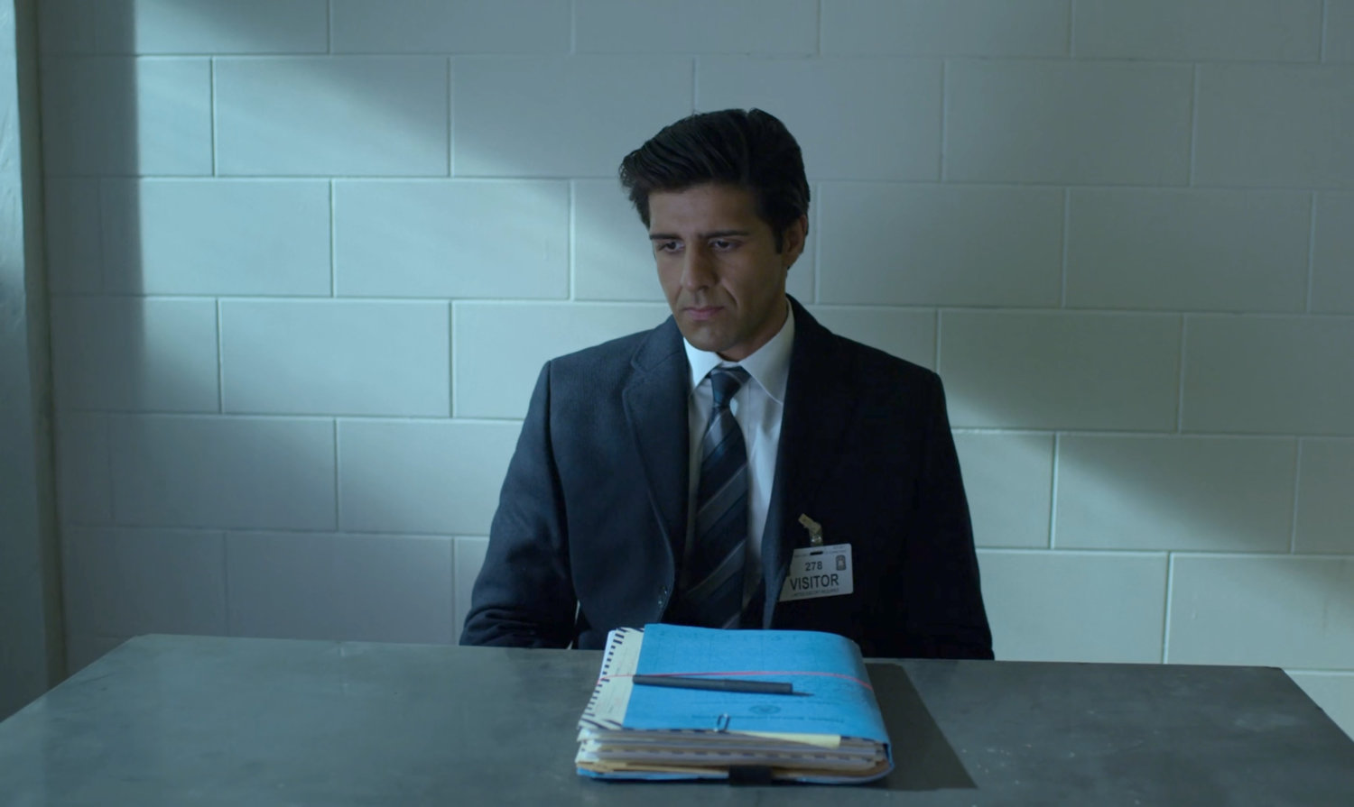 Ray Nadeem in the visitor area at Ryker's Island Penitentiary.