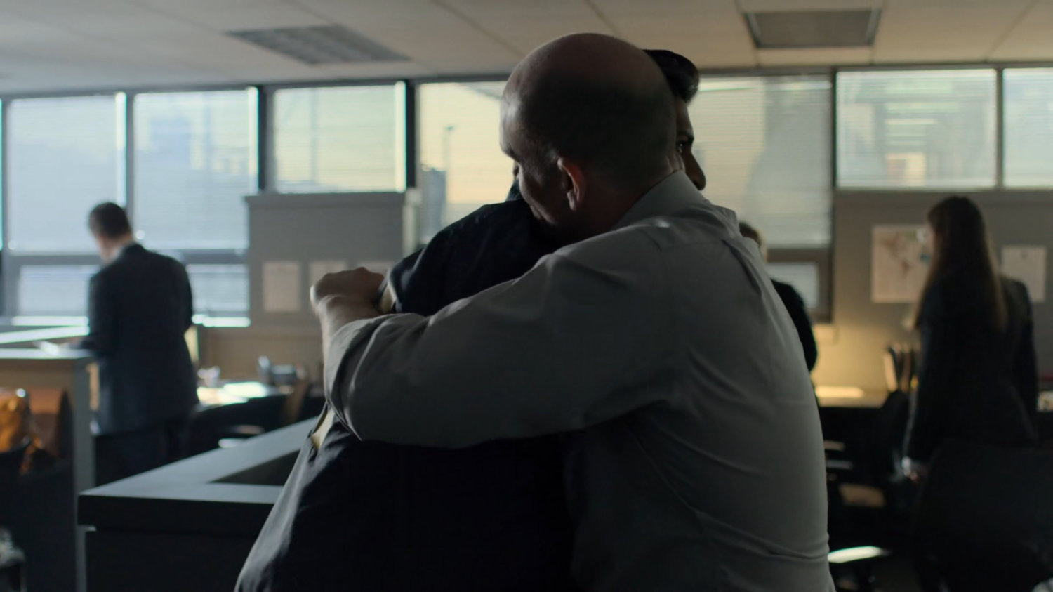 Nadeem hugs another officer in the FBI Offices.