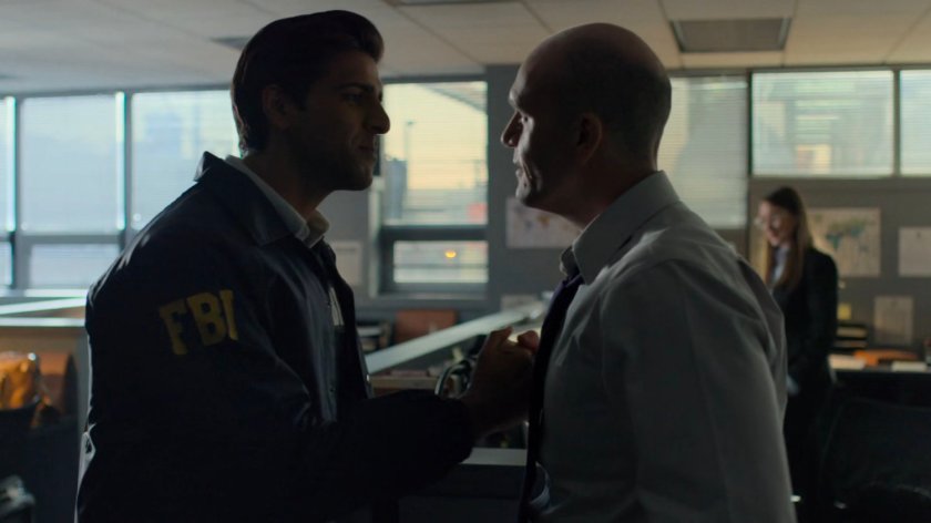 Nadeem speaks with another officer in the FBI Offices.