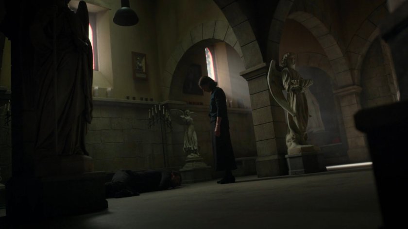 Maggie standing over Matt in the church basement.