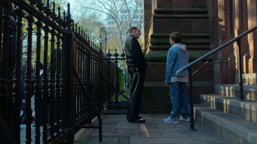 Young Matt speaks with Father Lantom outside the church.