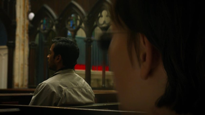 Young Matt listens to parishioners praying inside Clinton Church.
