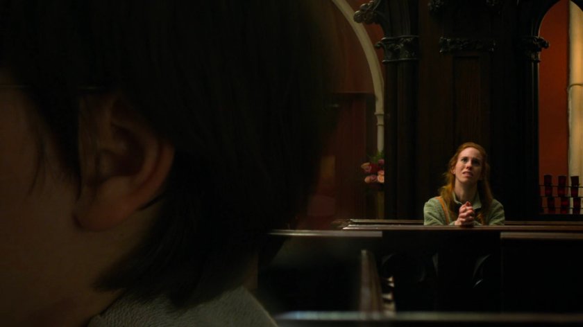 Young Matt listens to parishioners praying inside Clinton Church.