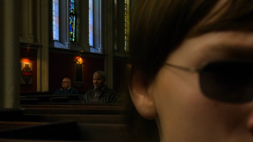 Young Matt listens to parishioners praying inside Clinton Church.