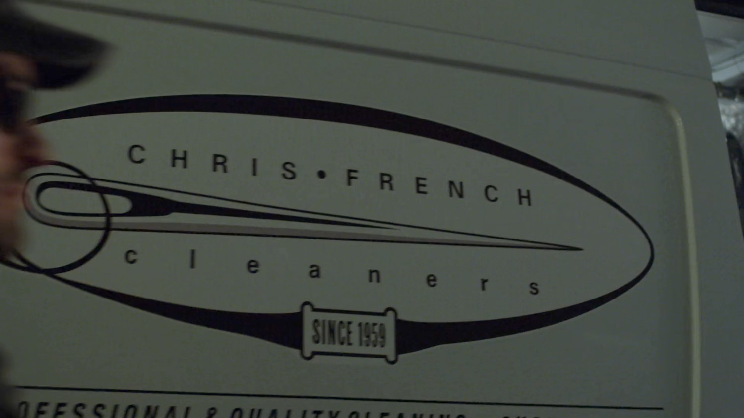 Sign for Chris French dry cleaners on side of van.