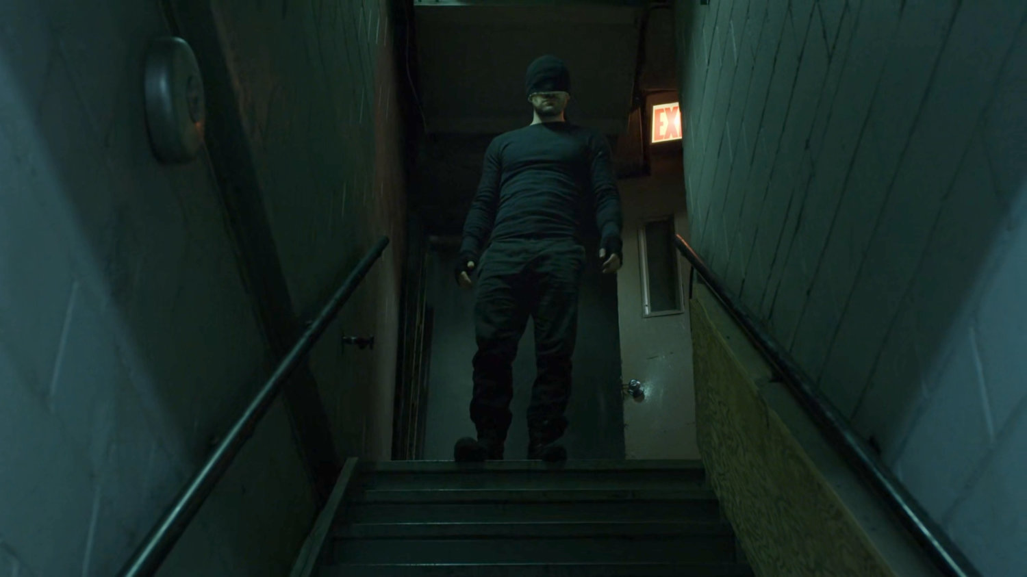 Matt descending stairs inside Chris French dry cleaners.