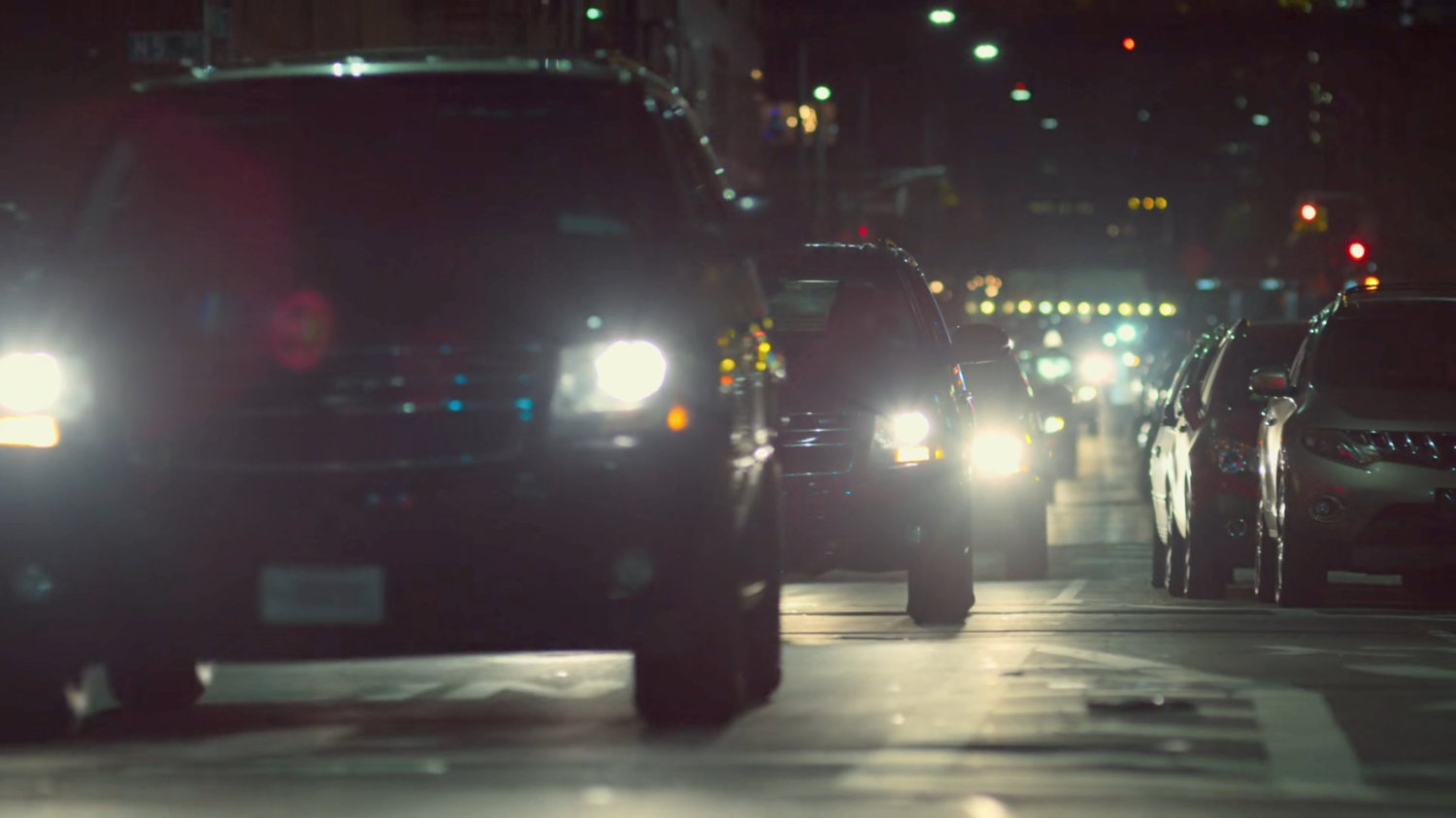 Fisk's FBI motorcade driving along dark street.