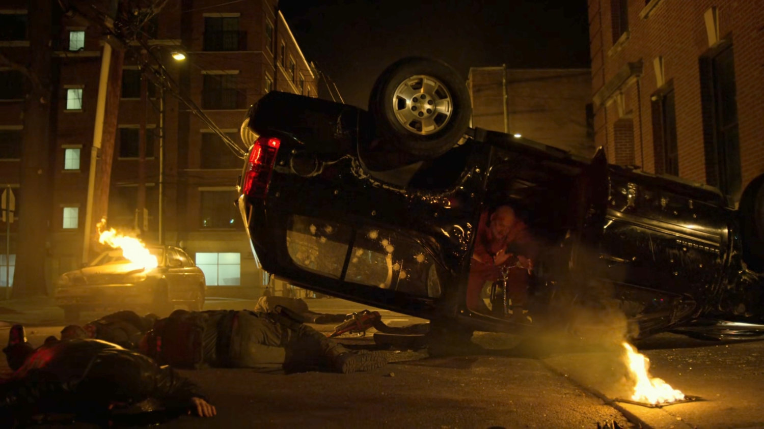 Fisk exits flipped FBI vehicle in the aftermath of car bombing.