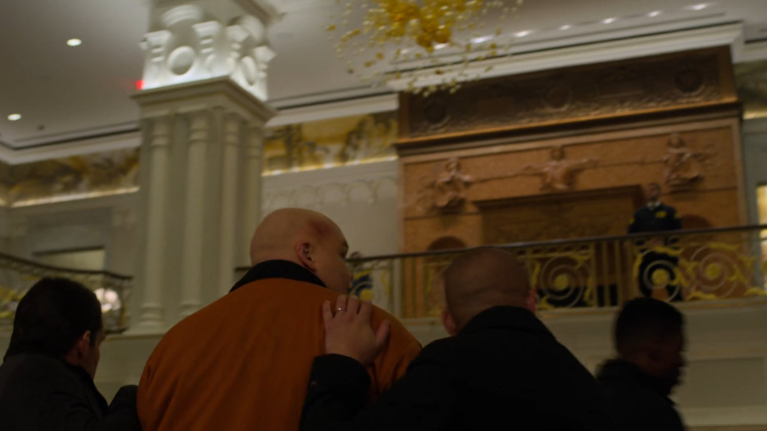 Fisk being escorted through the lobby the Presidential Hotel.