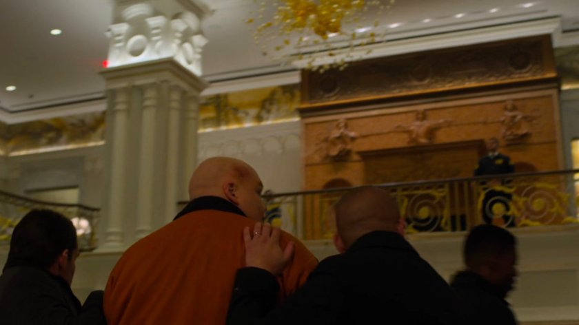 Fisk being escorted through the lobby the Presidential Hotel.