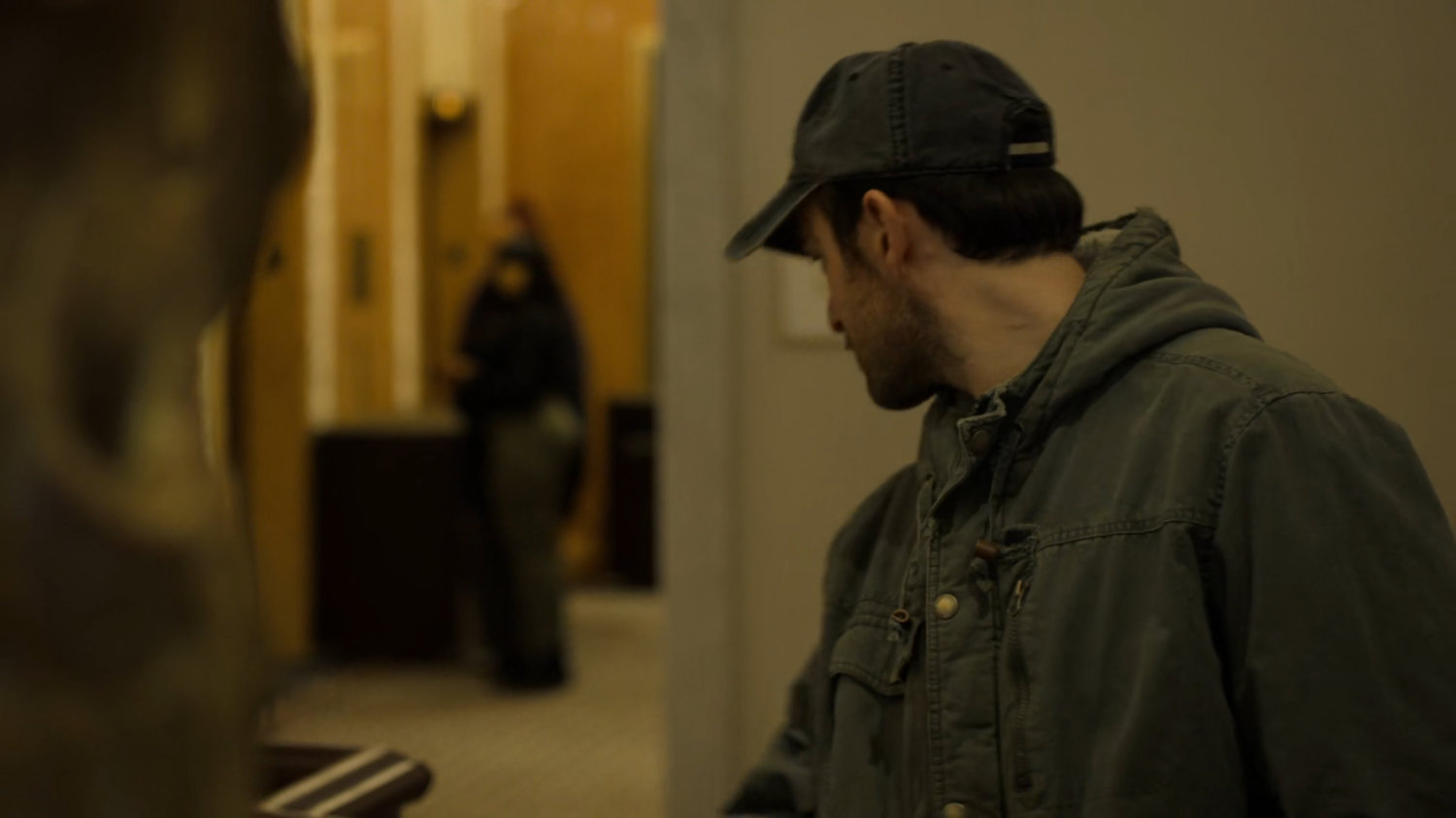 Matt eavesdropping on FBI agents by elevator in the Presidential Hotel.
