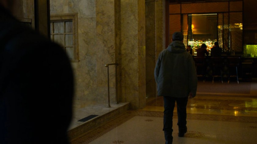 Matt walking away from Dex at the Presidential Hotel elevators.