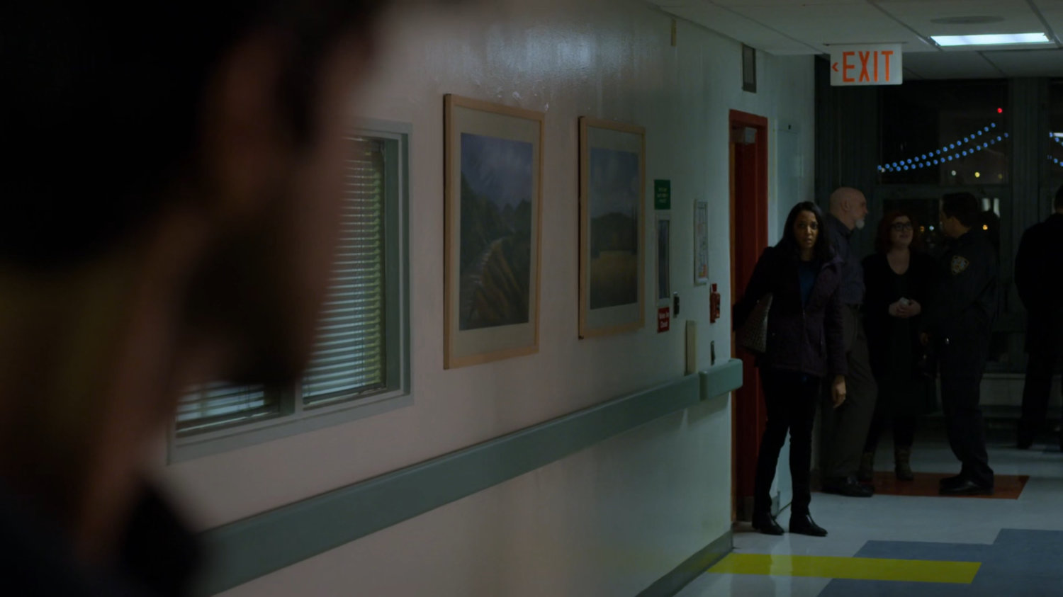 Nadeem's wife see shim in the hallway of the hospital.