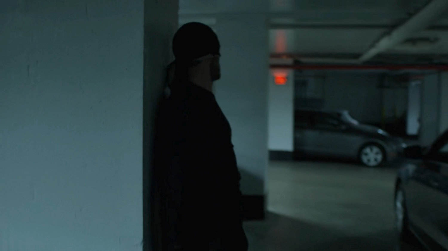 The Man in Black sneaking through the Hotel parking garage.
