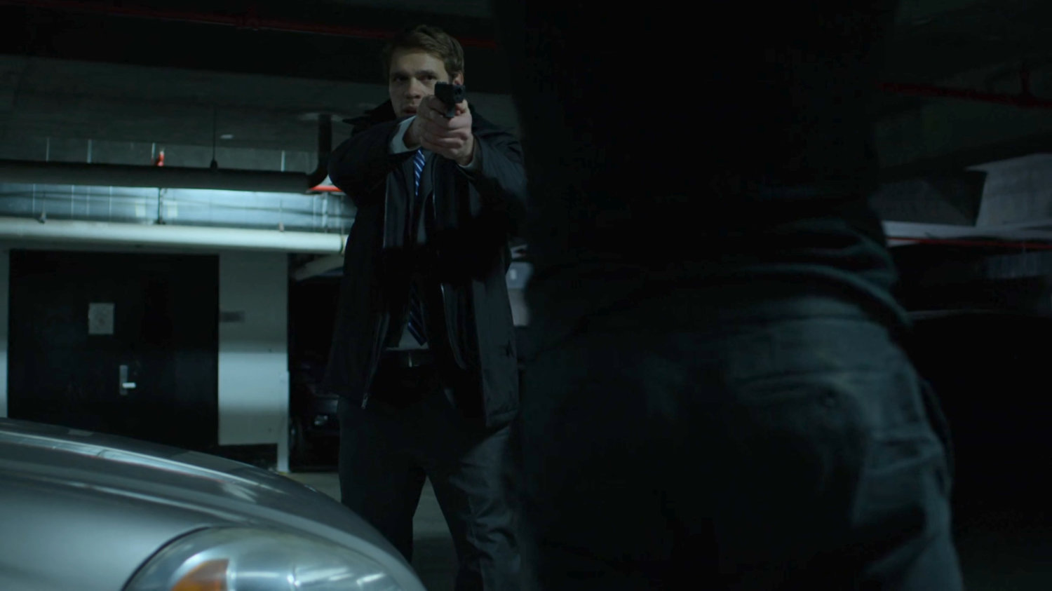 FBI Agent draws his gun on the Man in Black in the Hotel parking garage.