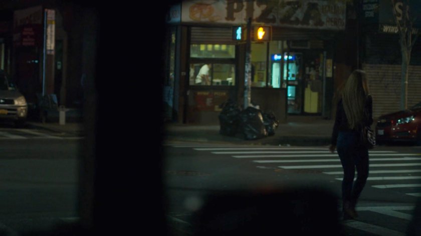 Dex spying on Julie crossing a street towards a pizza parlor.