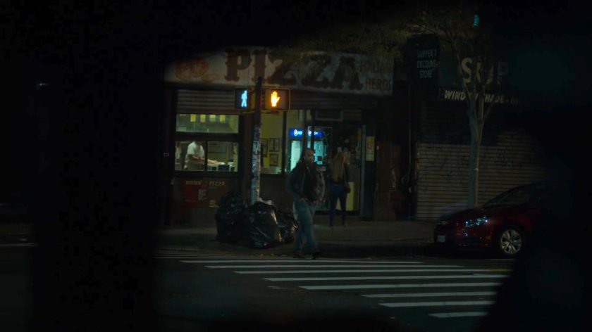 Dex spying on Julie entering a pizza parlor.