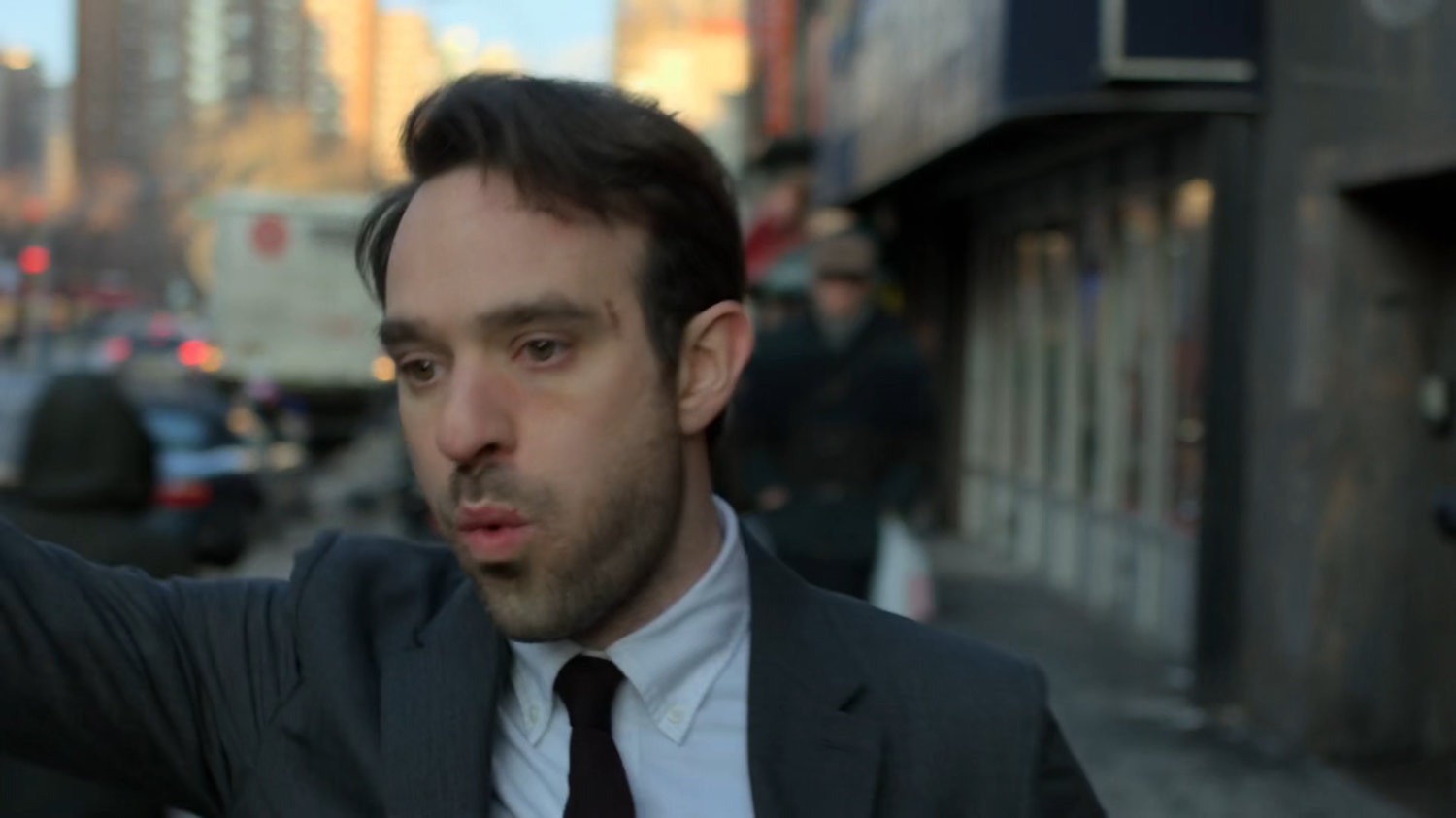Matt hailing a taxi from sidewalk.