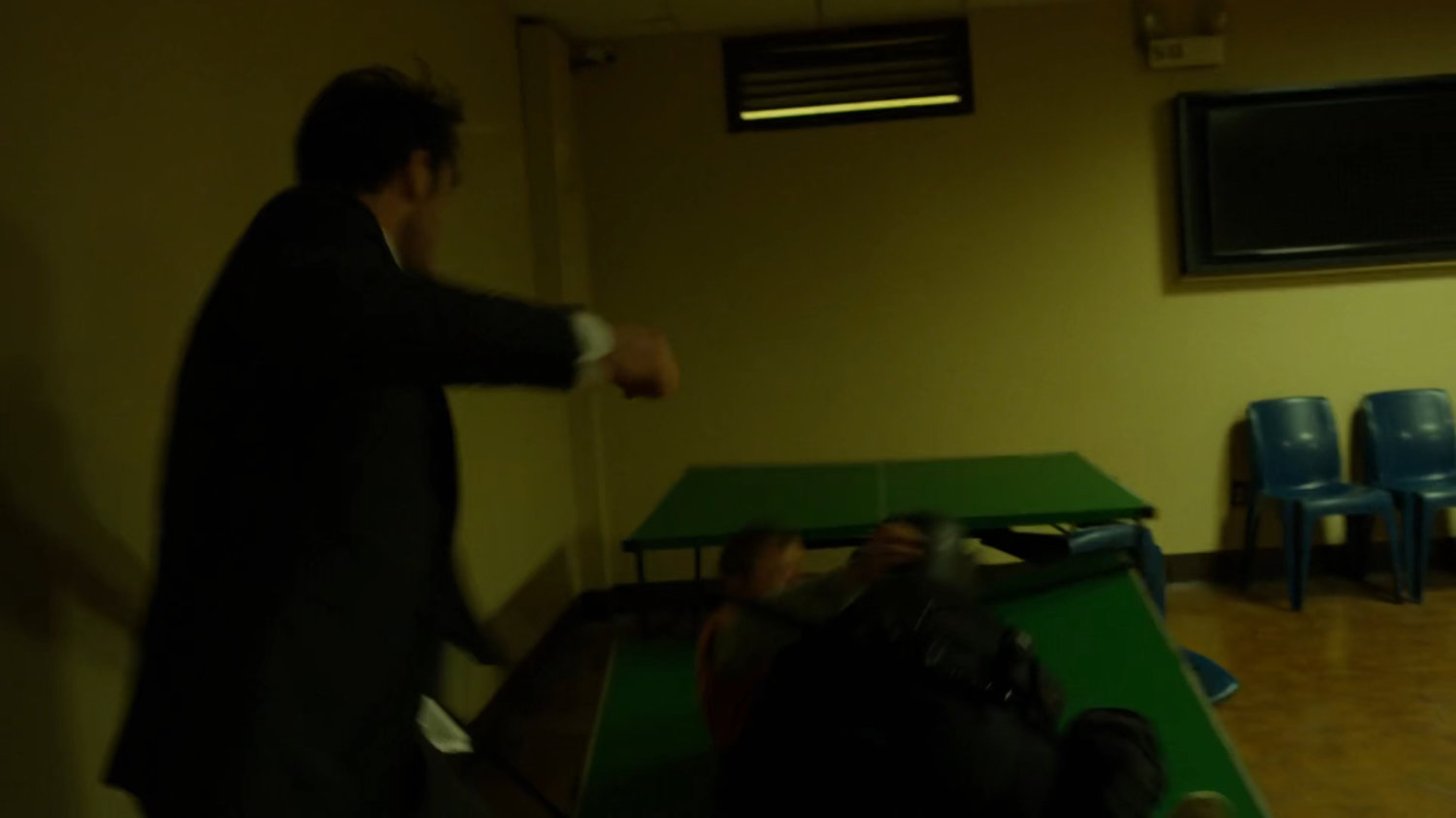 Matt avoiding fighting prisoners in penitentiary rec room.