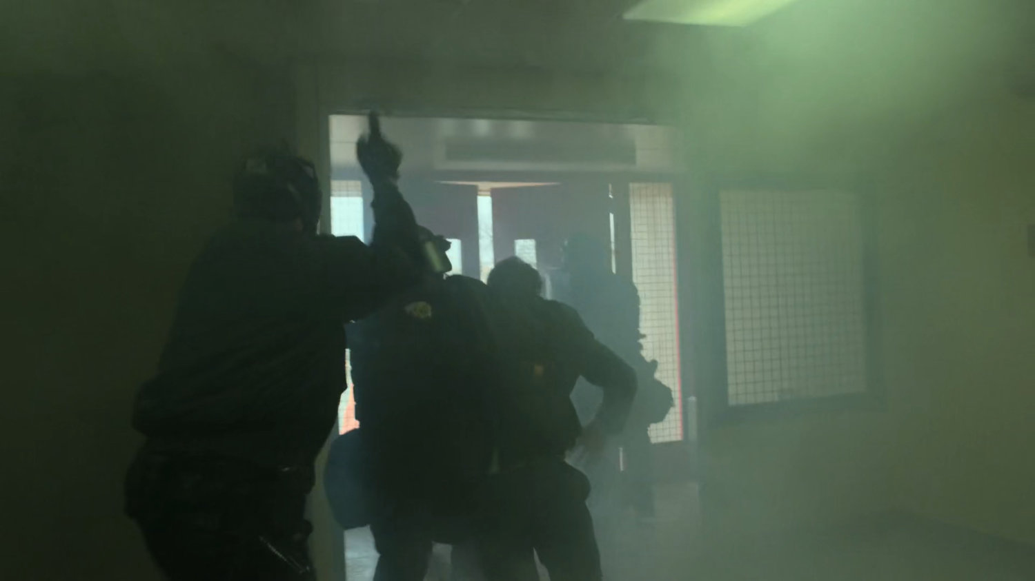 Guards lead Matt out of smoky entrance of penitentiary.