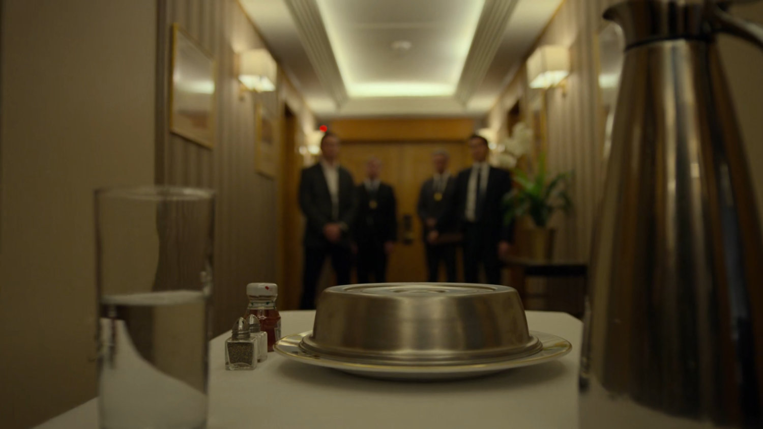 Catering cart and FBI agents in the hallway outside the penthouse of the Presidential Hotel.