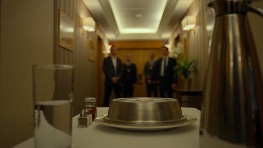 Catering cart and FBI agents in the hallway outside the penthouse of the Presidential Hotel.