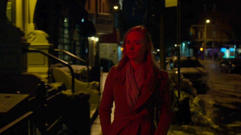 Karen walks along a dark sidewalk at night.