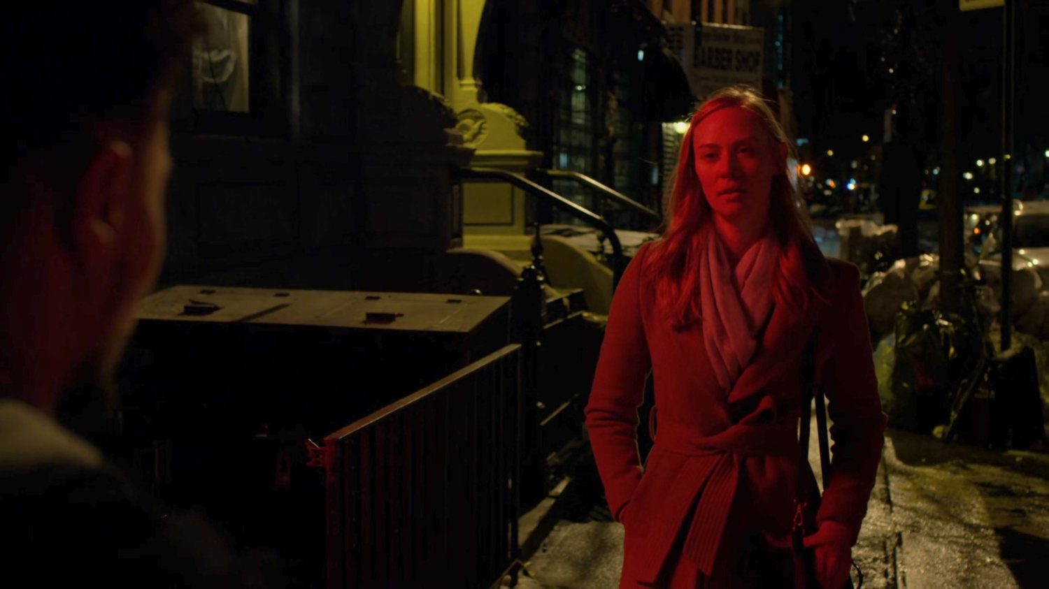 Karen confronts three youths on a dark sidewalk at night.