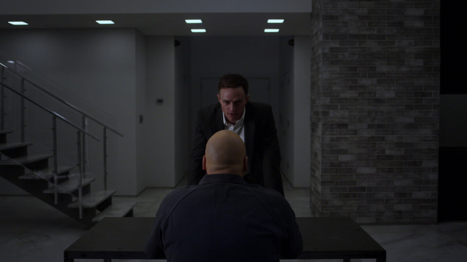 Dex confronts Fisk in the penthouse of the Presidential Hotel.