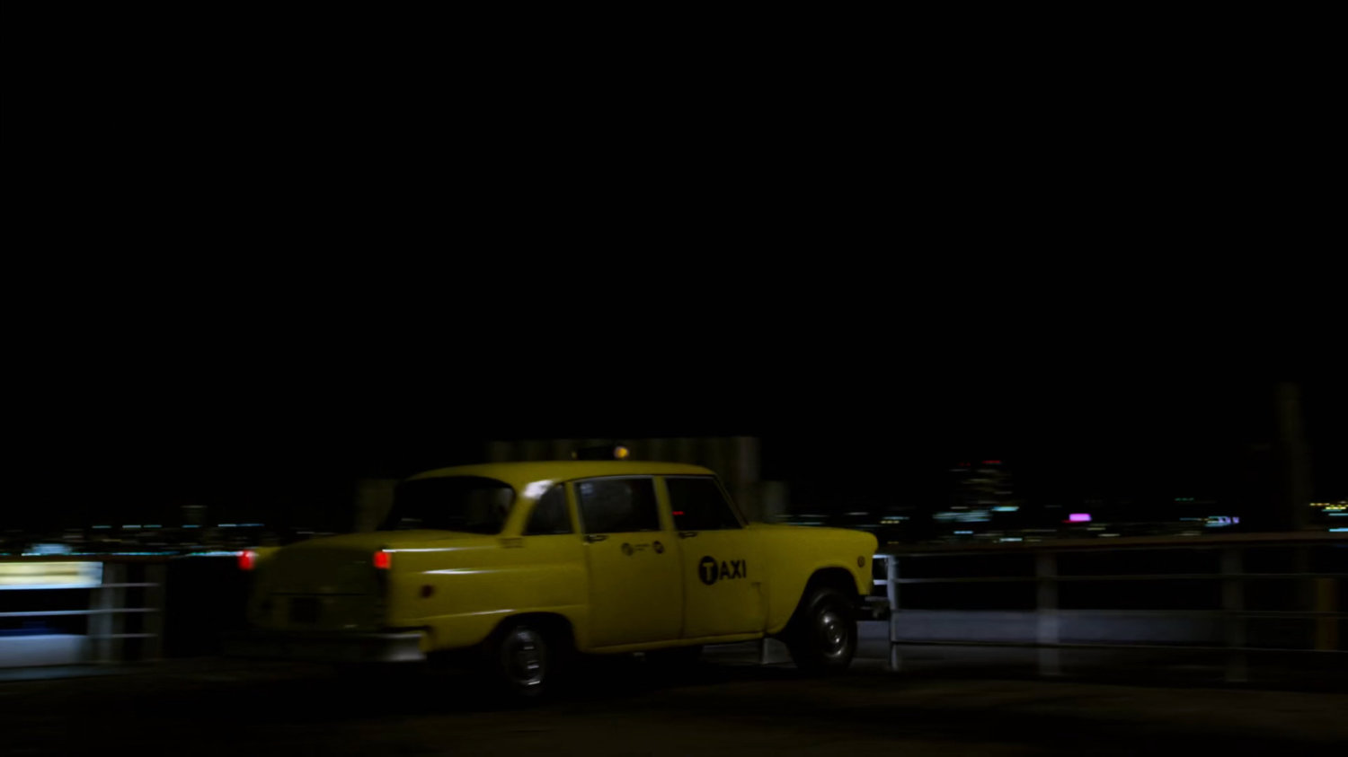 Cab racing along pier at night.
