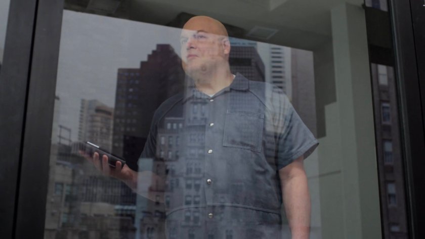 Fisk looking out the window of the penthouse of the Presidential Hotel.