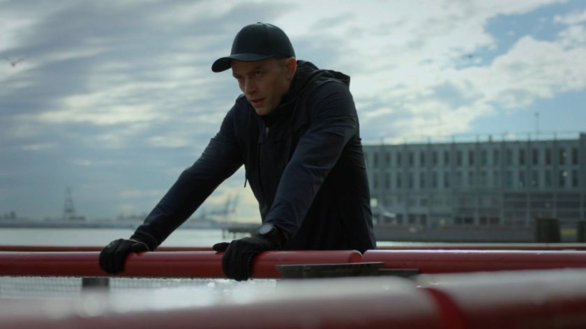 Dex leaning on a railing by the path under FDR drive.