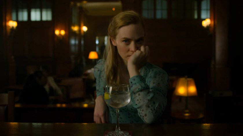 Karen sits at a bar in a social club.