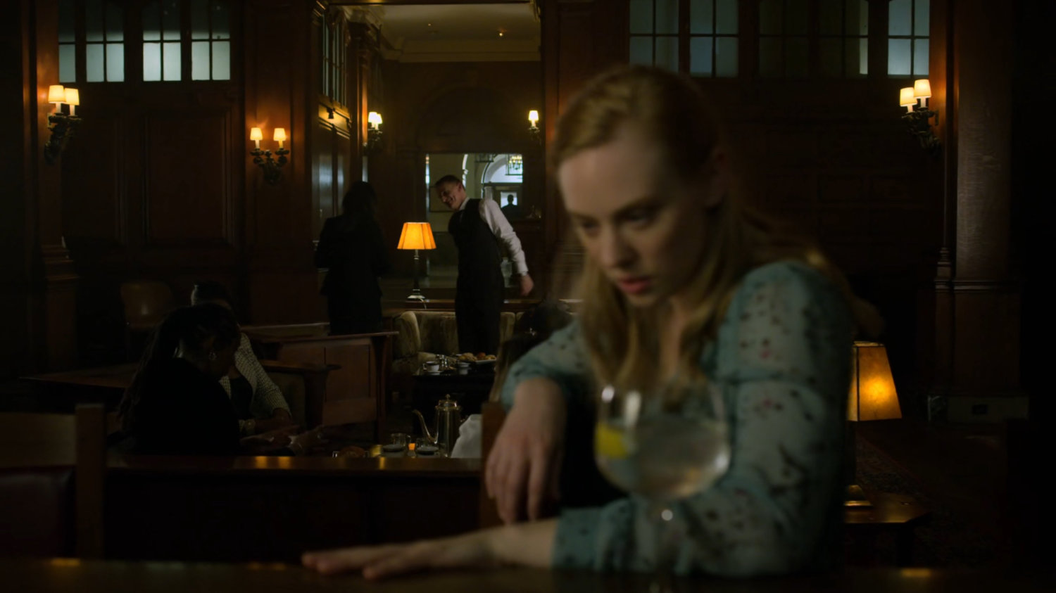 Karen sits at a bar in a social club.