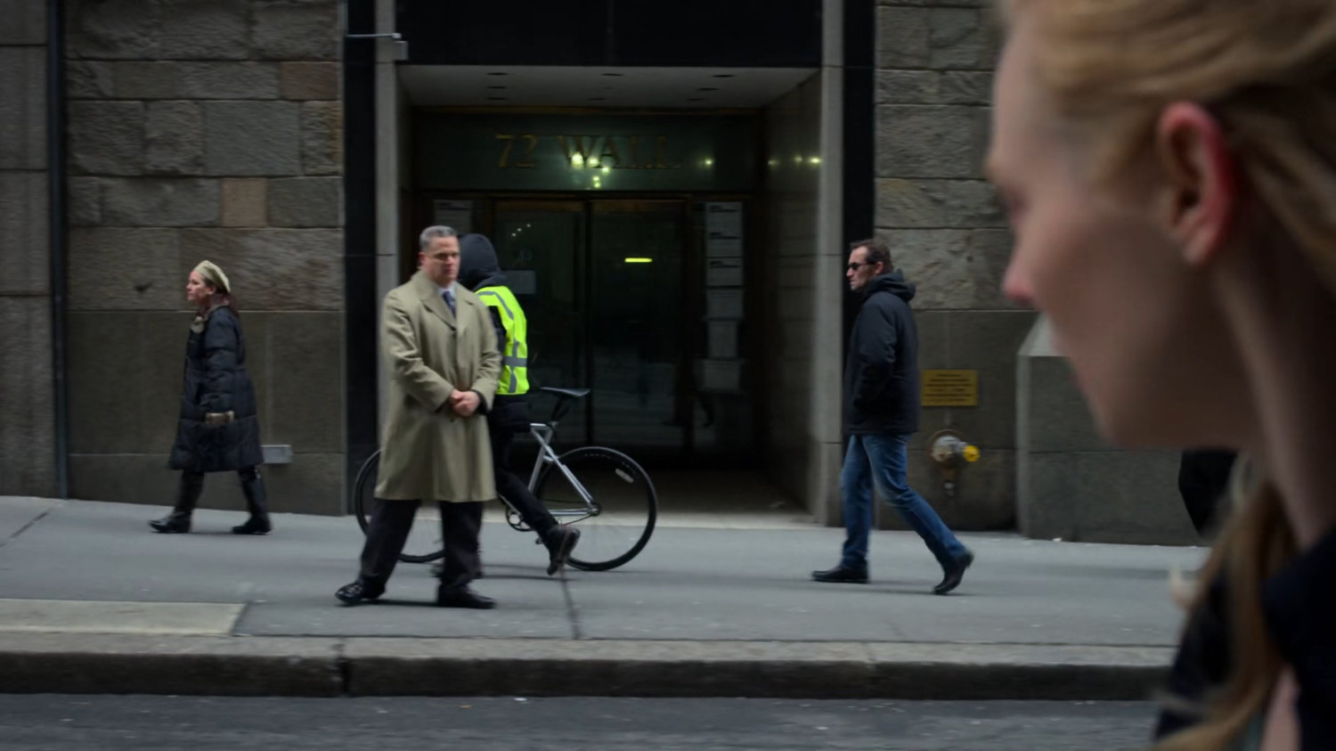 A man watching Karen from across the street.