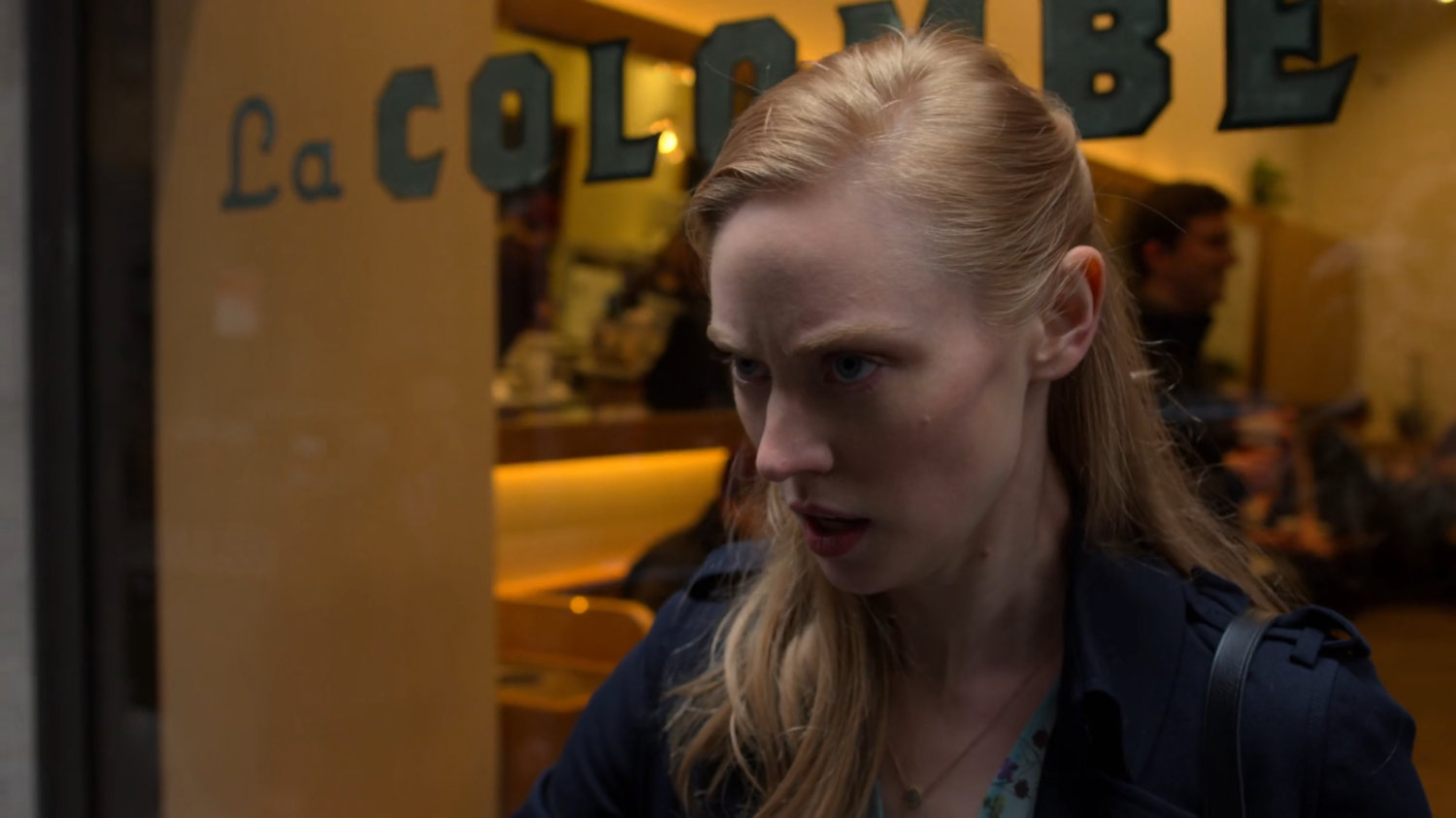 Karen glaring at FBI agents from a Wall Street sidewalk.
