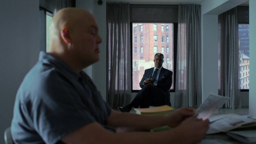 Donovan watches Fisk as he reads through Dex's surveillance file in the penthouse of the Presidential Hotel.