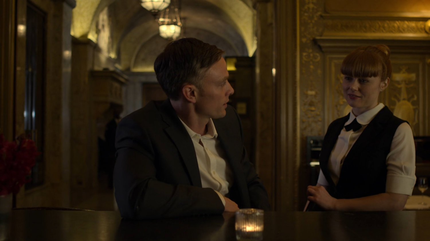 Dex talking to Julie at the bar in the Presidential Hotel.