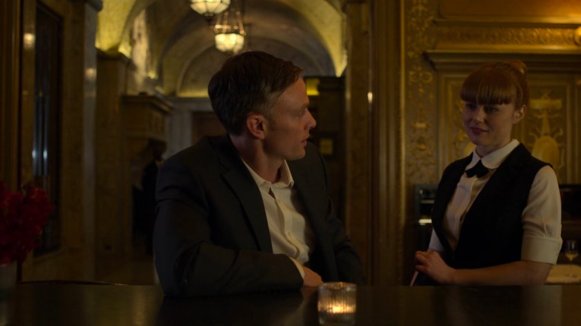 Dex talking to Julie at the bar in the Presidential Hotel.