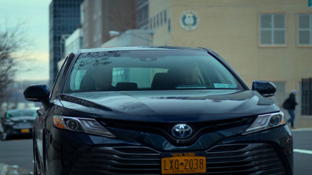 Karen and Foggy talking in a car parked on the street.