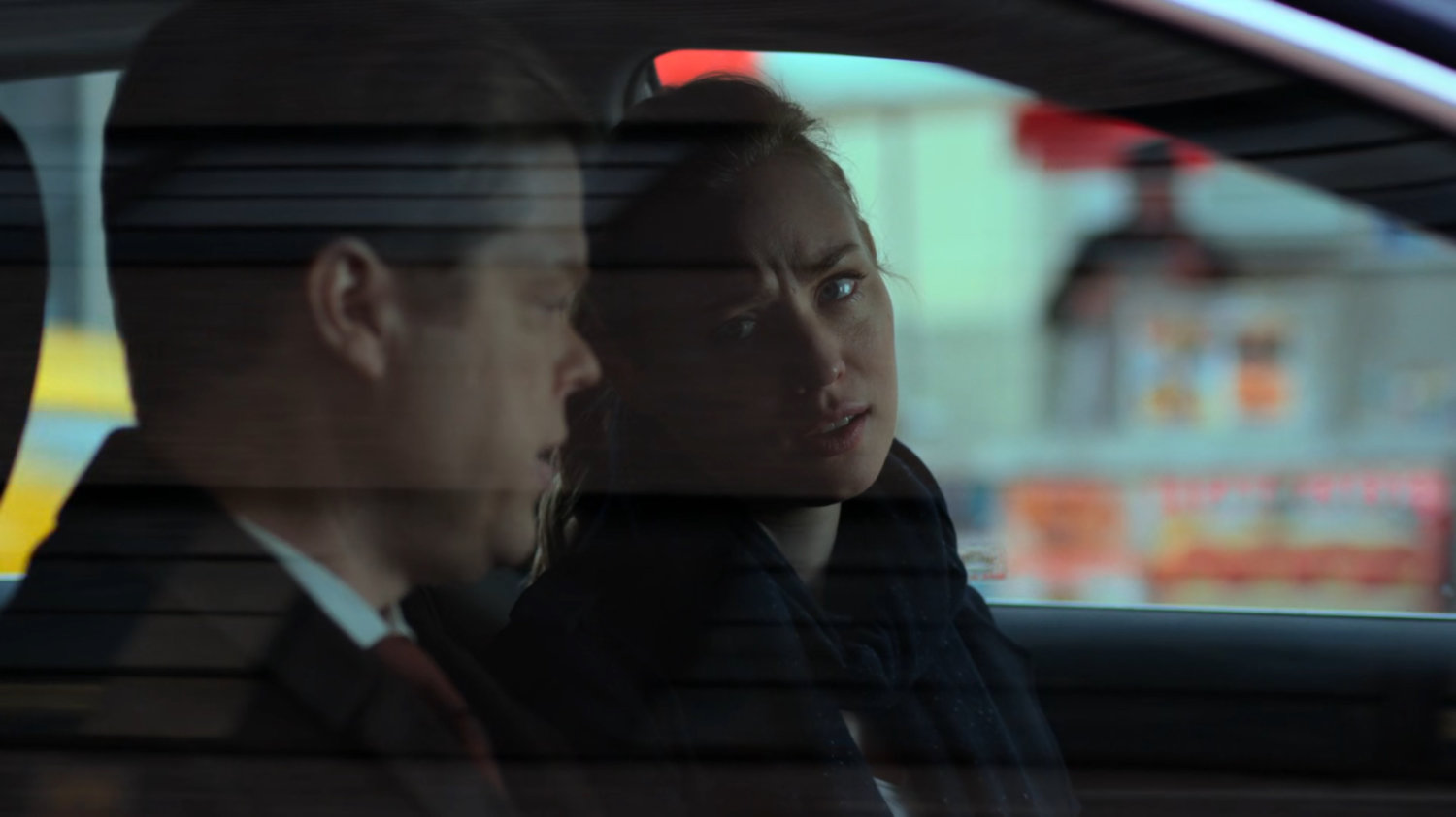Karen and Foggy talking in a car parked on the street.